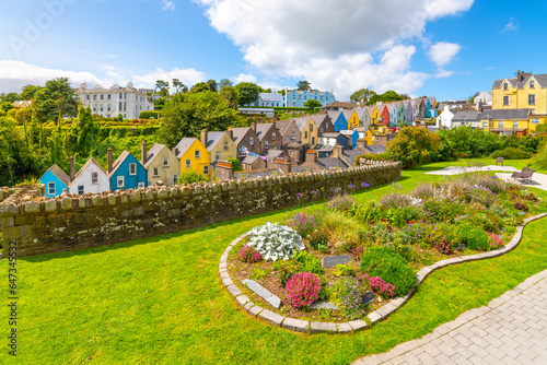 The picturesque and colorful Deck of Cards, a row of brightly painted townhomes, is seen from the Garden of Reflection park in the coastal town of Cobh, Ireland, Cork County. photo