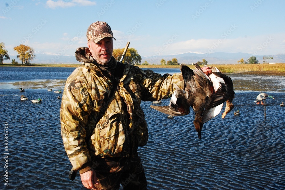 Naklejka premium Waterfowl hunter with ducks