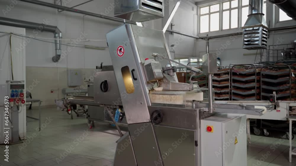 Production conveyor for slicing and packaging bread indoors. Mechanism for food production Production conveyor for slicing and packaging bread indoors. Mechanism for food production