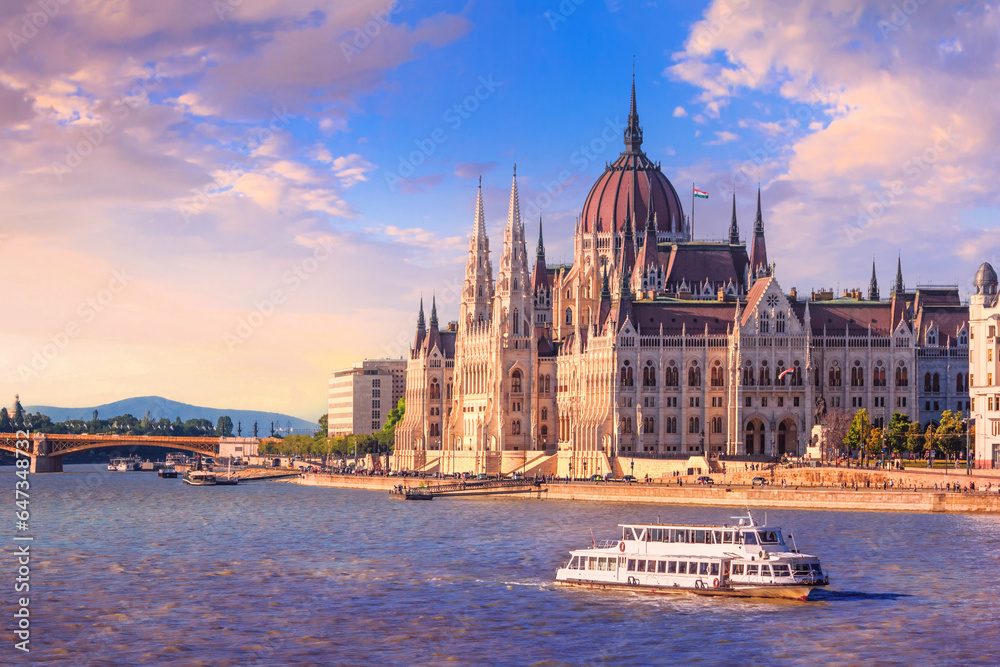 Fototapeta premium City summer landscape at sunset - view of the Hungarian Parliament Building and Danube river in the historical center of Budapest, Hungary