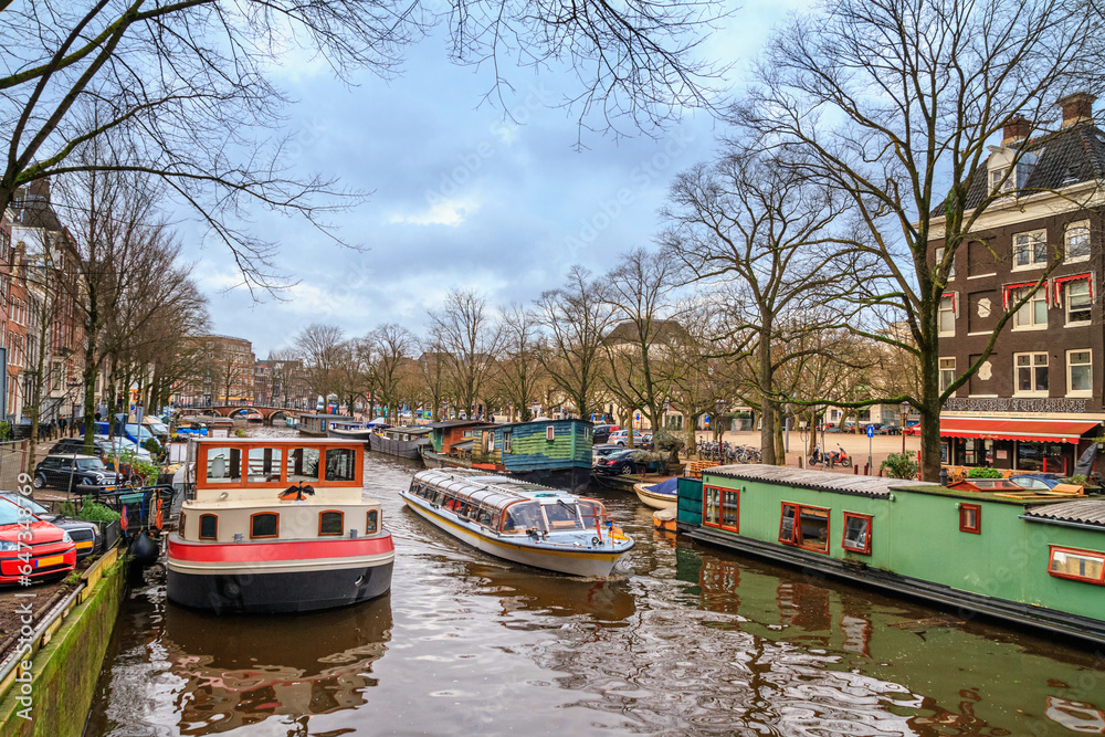 Cityscape - view of the water canal with houseboats in the historic center of Amsterdam, the Netherlands