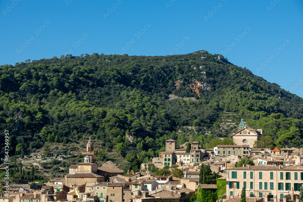 View of the pretty Mallorcan village of Valldemossa, in the protected natural area of the Sierra de Tramuntana, on a sunny summer morning