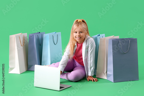 Little girl with laptop and...