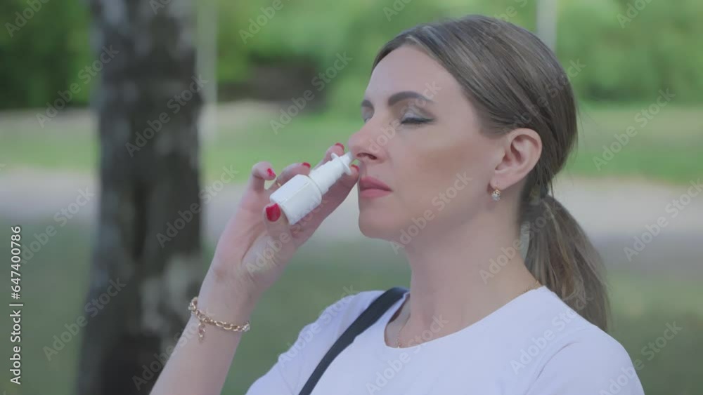 Face of sick woman who uses medicine spray for nasal breathing. Face of sick woman who uses medicine spray for nasal breathing.