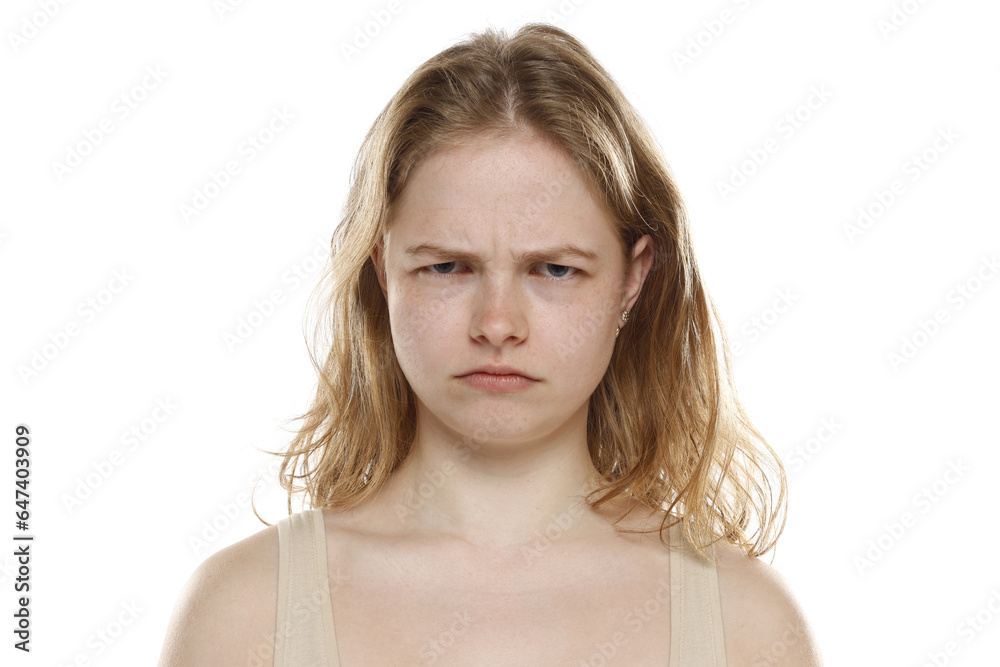 Portrait of young beautiful angry blonde woman with no makeup on white background Portrait of young beautiful angry blonde woman with no makeup on white background