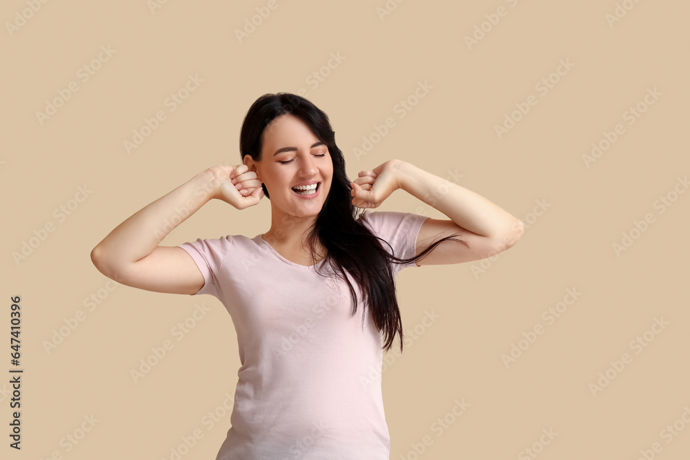 Portrait of happy young brunette on beige background Portrait of happy young brunette on beige background