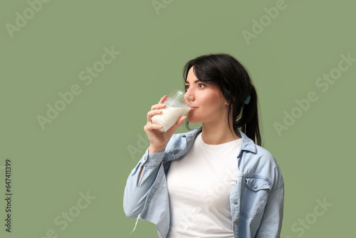 Pretty young woman drinking...