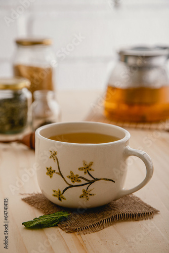 close up of ceramic mug tea with hand painted flowers 