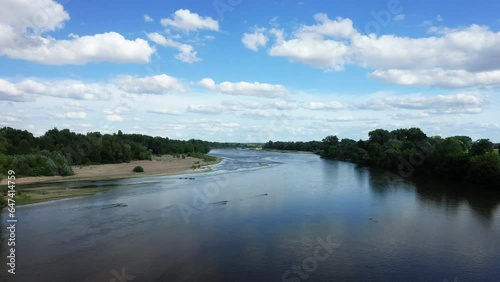 The Loire river in the middle of the green countryside in Europe, France, Burgundy, Nievre, Pouilly sur Loire, towards Nevers, in summer on a sunny day.  photo