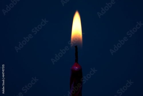 Photography Burning candle with dark blue background