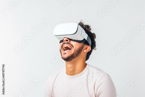 Young excited man trying on virtual reality simulator glasses in his living room, having fun and smiling while looking at virtual realty © VisualProduction