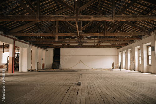 Fotografi Very old abandoned factory warehouse with wooden floors and windows and clay tiles