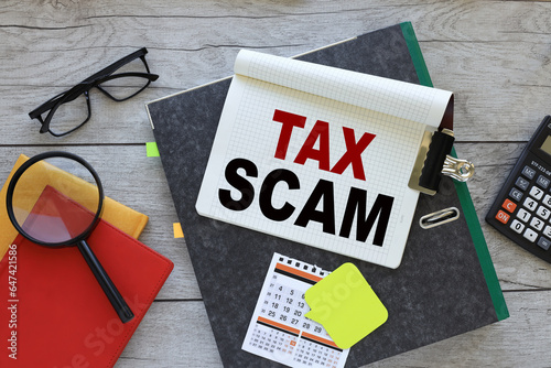 Wallpaper Mural tax scam, text on a notebook on a folder. red notepad. magnifying glass Torontodigital.ca