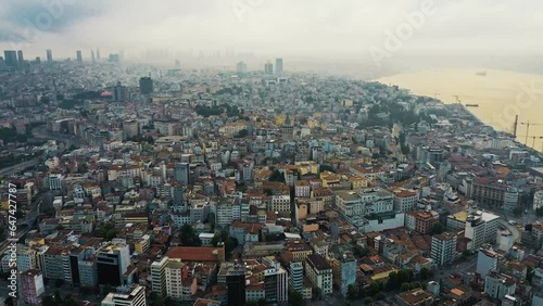 Aerial drone footage over buildings towards Galata Tower. Panoramic view of Istanbul, Turkey. photo