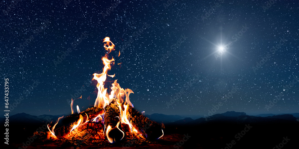 Naklejka premium A christmas star shines at night over the mountains of Bethlehem