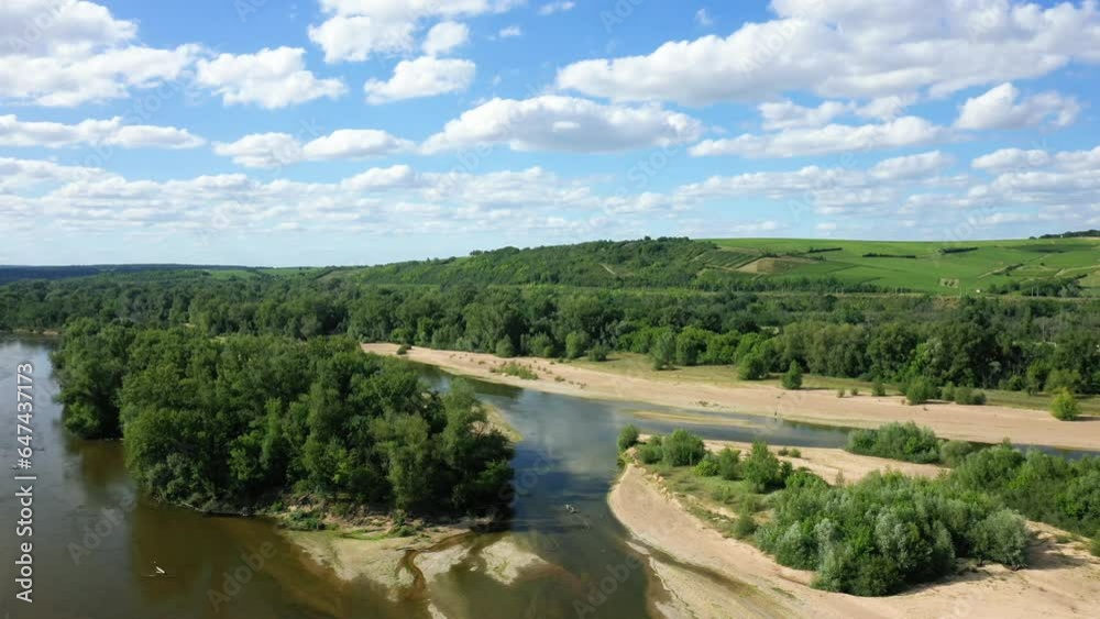The Loire river winding among green vineyards in Europe, France, Burgundy, Nievre, Pouilly sur Loire, towards Nevers, in summer, on a sunny day. The Loire river winding among green vineyards in Europe, France, Burgundy, Nievre, Pouilly sur Loire, towards Nevers, in summer, on a sunny day.