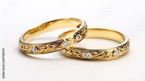 Two exquisite gold wedding rings on a white background.