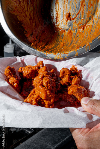 Person cooking some delicious boneless with buffalo sauce