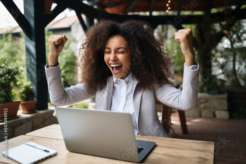 Excited happy african american woman feeling winner rejoicing online win got new job opportunity, overjoyed motivated mixed race girl student receive good test results on laptop celebrating admission