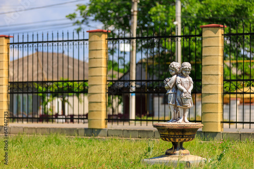 Little boy and girl, old sculpture. Background with selective focus and copy space