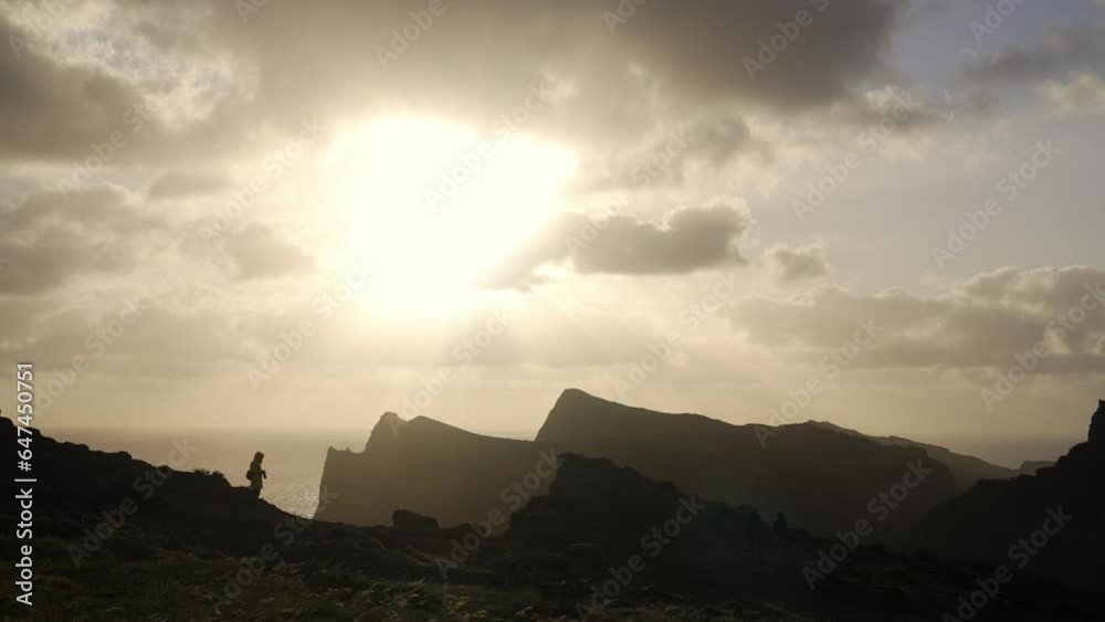 Beautiful views of a sunrise at Miradouro da Ponta do Rosto on a windy day with clouds, cliffs and blue water