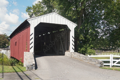 Red and White Wood Frame Covered Bridge in Summer © Monica