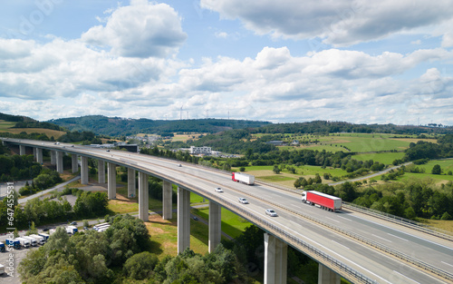 aerial view of a highway bridge going over the valley in the beautiful countryside