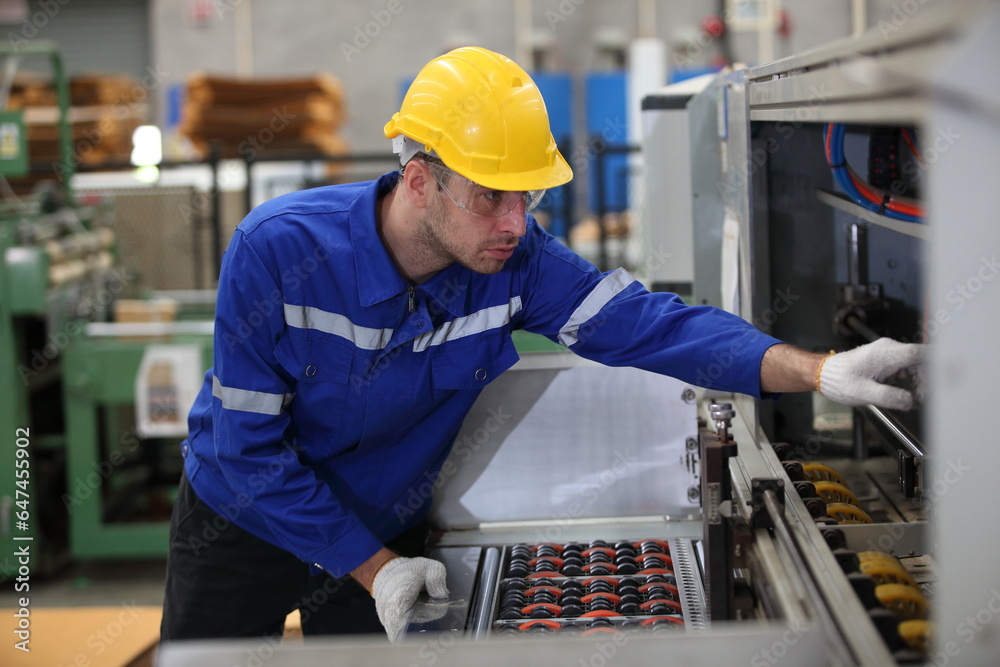 worker or engineer working in factory with safety uniform , safety hat and safety glasses , image is safety concept or happy workplace worker or engineer working in factory with safety uniform , safety hat and safety glasses , image is safety concept or happy workplace