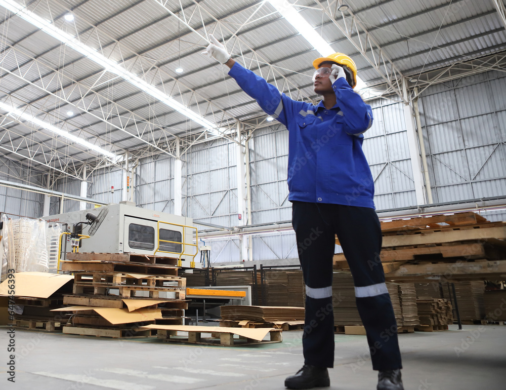 worker or engineer working in factory with safety uniform , safety hat and safety glasses , image is safety concept or happy workplace worker or engineer working in factory with safety uniform , safety hat and safety glasses , image is safety concept or happy workplace