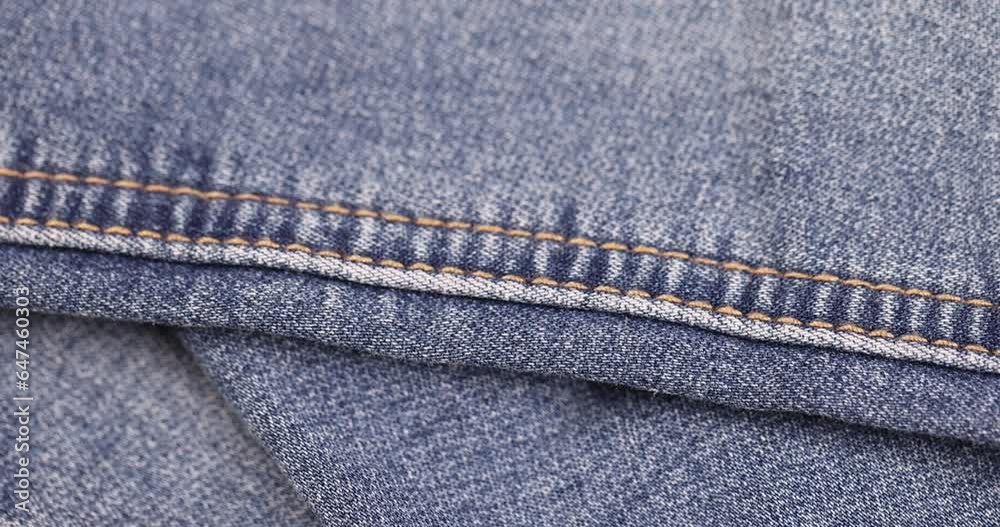 blue denim fabric made of cotton, details of a piece of clothing sewn from blue denim blue denim fabric made of cotton, details of a piece of clothing sewn from blue denim