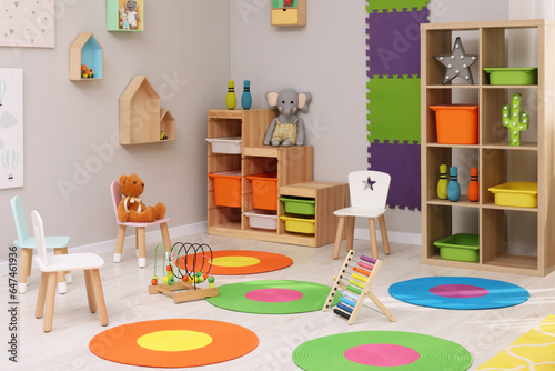 Child s playroom with different toys and furniture. Cozy kindergarten interior