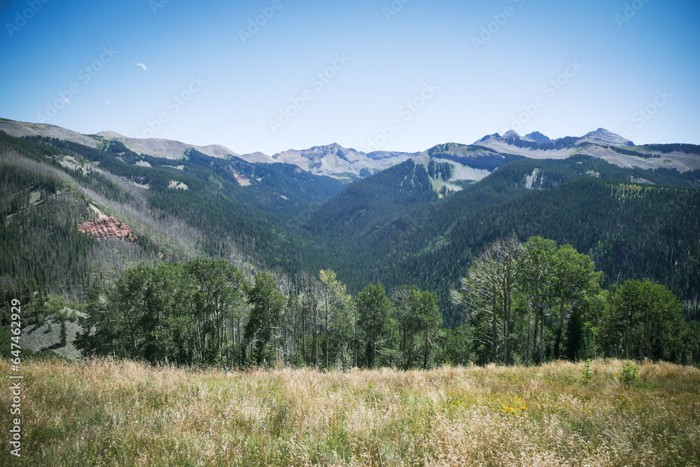 View of San Juan Mountain Range near Rico and Telluride Colorado with red rock cliffs on beautiful blue sky summer day