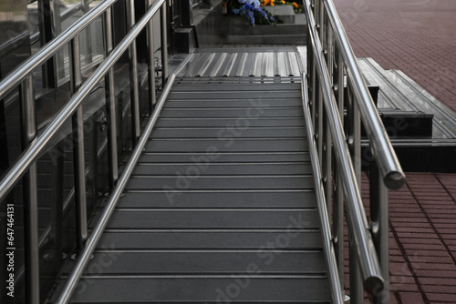 Ramp with metal railings near building outdoors