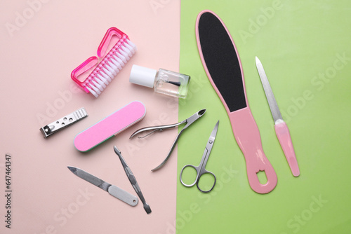 Set of pedicure tools on color background, flat lay
