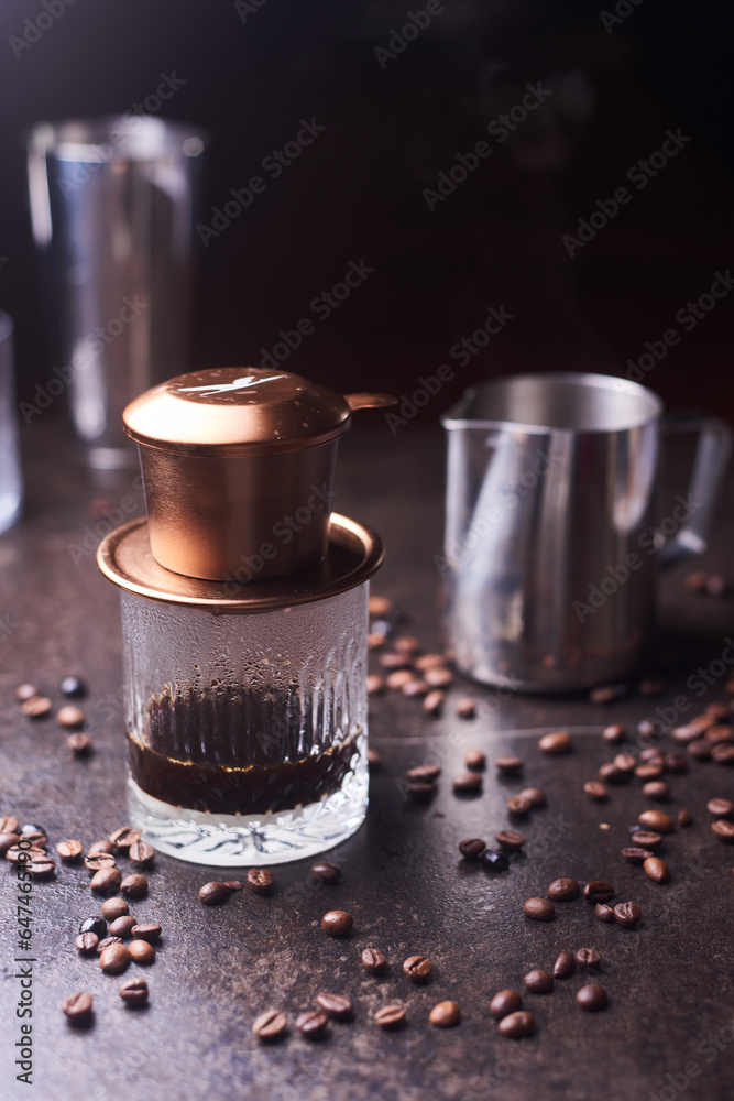 Vietnamese coffee. Coffee cup and beans on a dark table