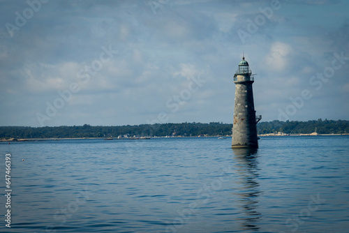 solitary stone lighthouse in Boston Harbor Massachusetts.