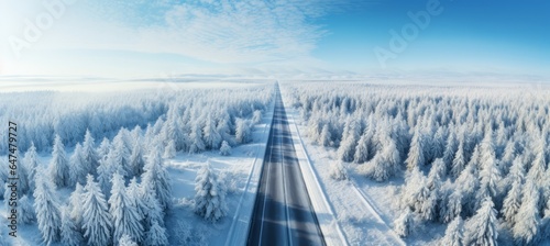 Aerial view road between the winter season forest. Generative AI technology. © Hero Design