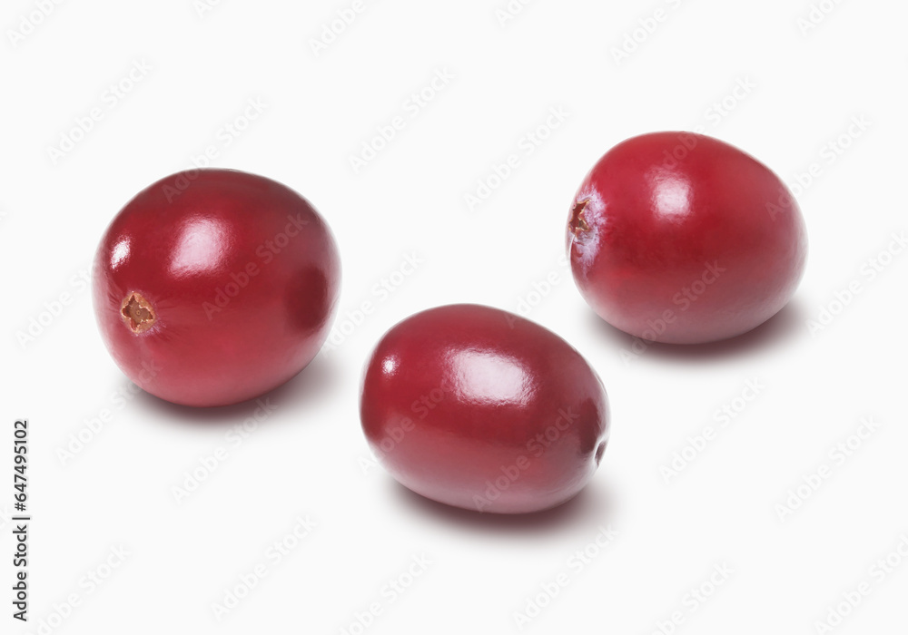 Three Cranberries On A White Background; Toronto, Ontario, Canada Three Cranberries On A White Background; Toronto, Ontario, Canada