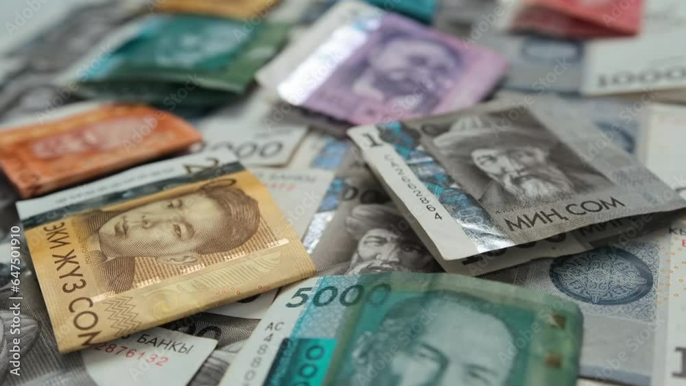 Close-up, banknotes worth 5000, 1000, 500 100 and 50 Kyrgyz som, slowly tracking shot, low angle. Concept finance business investment success. Close-up, banknotes worth 5000, 1000, 500 100 and 50 Kyrgyz som, slowly tracking shot, low angle. Concept finance business investment success.