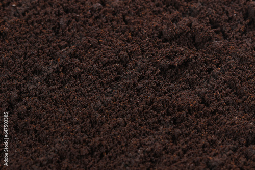 ground coffee brown background, food grain texture