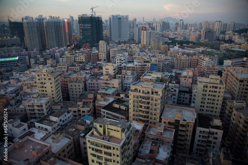 Modern architecture surrounds older buildings in Shenzhen; Shenzhen, Guangdong, China photo