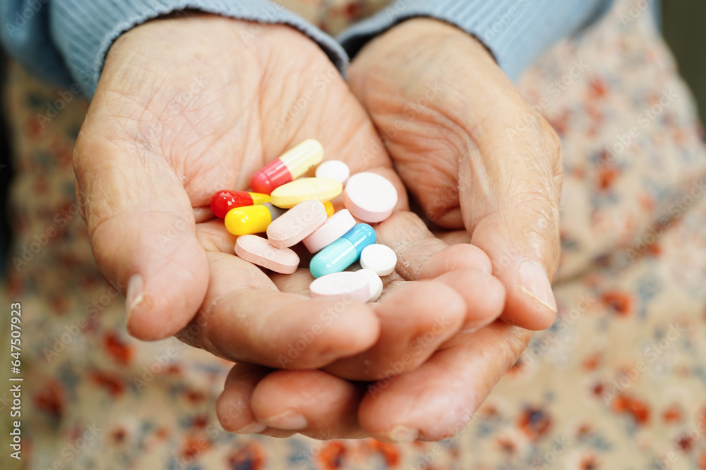Asian elderly woman holding pill drug in hand, strong healthy medical concept. Asian elderly woman holding pill drug in hand, strong healthy medical concept.