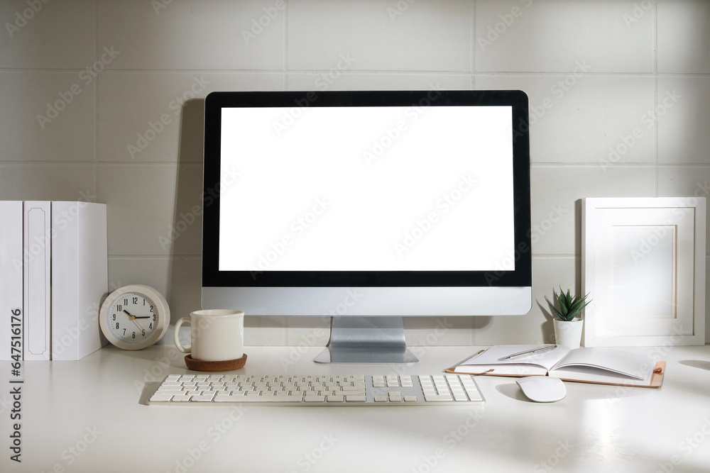 Fototapeta premium Minimal workspace with white screen computer and office supplies on white table.