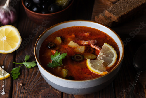 Solyanka soup decorated with lemon slices