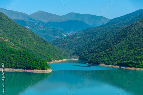 Landscape with a mountain lake in a blue haze in the morning.