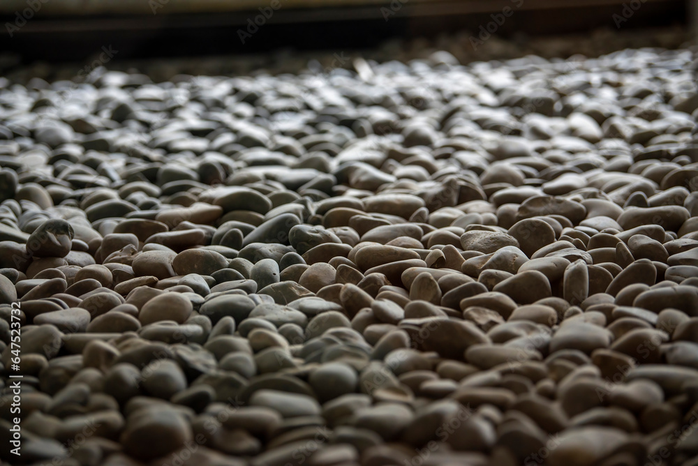 Obraz premium Close-up of a sculpture composed of a pile of stones and pebbles indoors