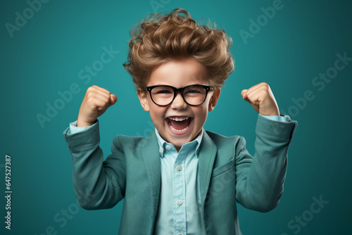 happy winner school boy isolated on blue background celebrates new success  power  energy. Yes  
