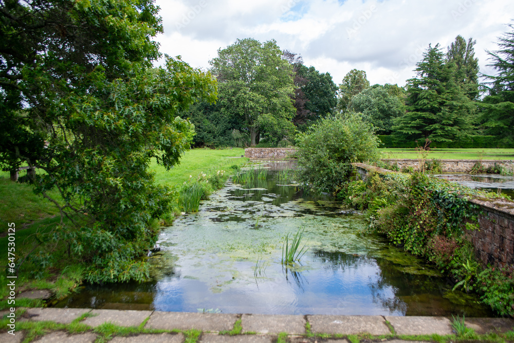 Fototapeta premium ILMINSTER, SOMERSET, ENGLAND-AUGUST 10 2023: Sunny summer weather drew tourists and visitors to enjoy the beautiful Tudor manor house and gardens at Barrington Court