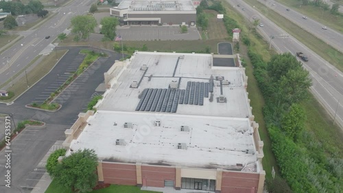 solar panels at the rooftop of building, aerial jib shot photo