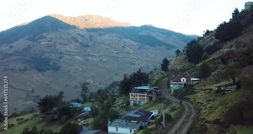 Aerial shot of houses on the mountains of Nebaj, Quiche in Guatemala, during the morning photo